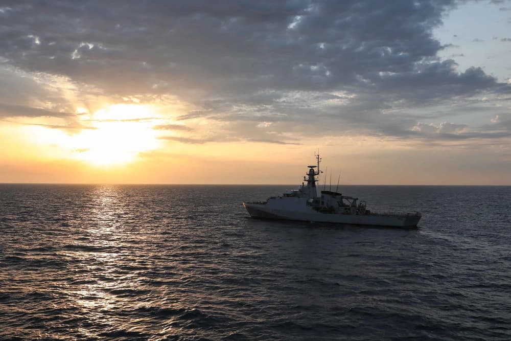 HMS Trent underway at sea near sunset